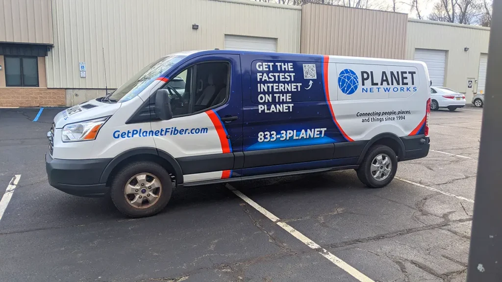 Planet Networks Ford Transit service van with branded wrap graphics